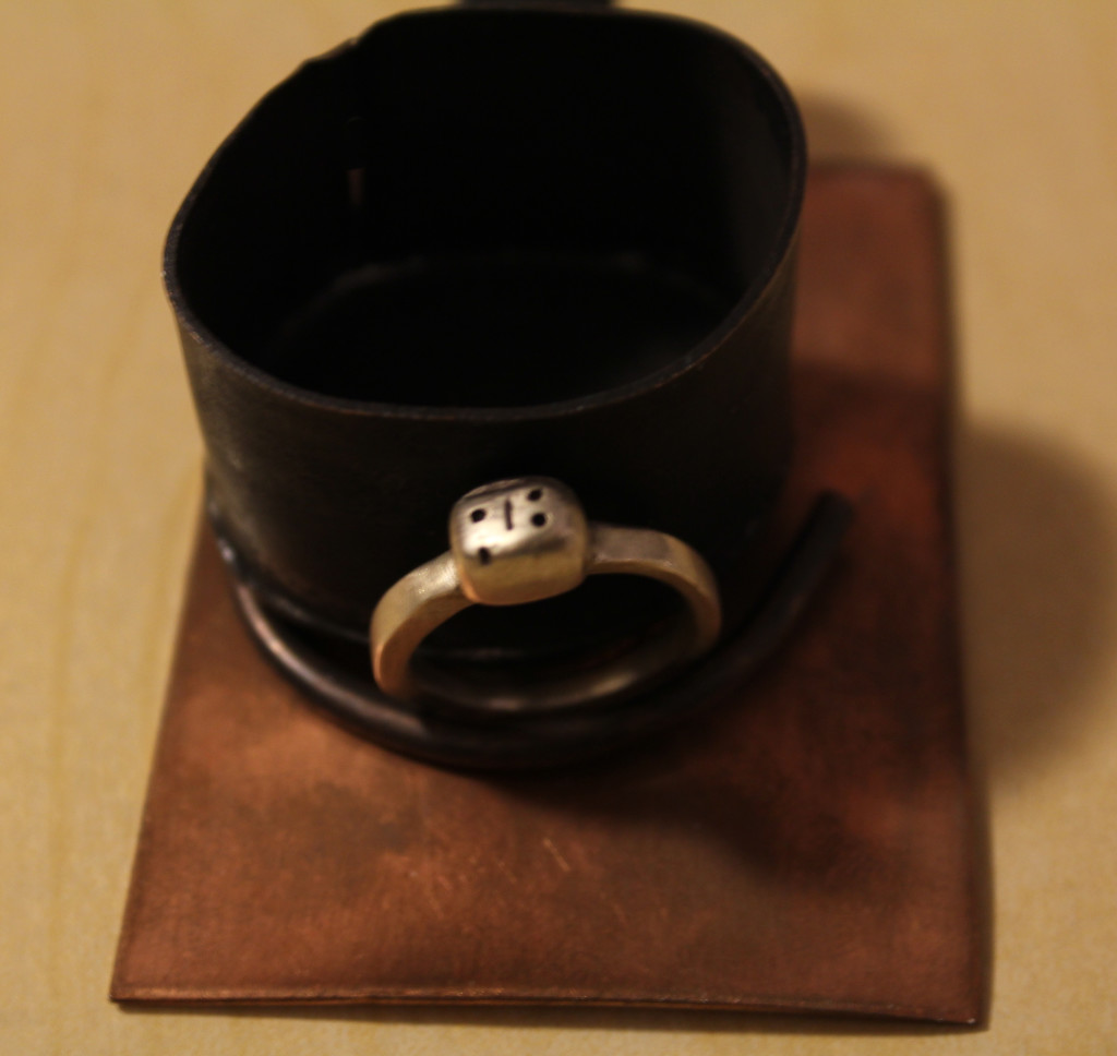ladybug silver ring on copper burner with frying pan and copper display